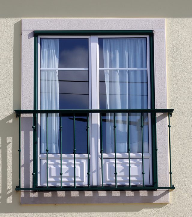 large window with metal railing outside. window with french balc